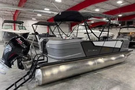 Slide: The Image of 2025 Sylvan A-22 pontoon boat in showroom, featuring sleek design and modern outboard motor. - 3