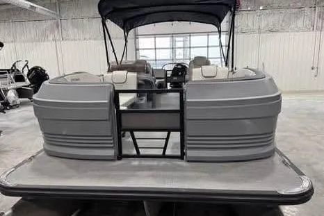 Slide: The Image of 2025 Sylvan A-22 pontoon boat in a showroom, featuring modern design and spacious seating. - 5