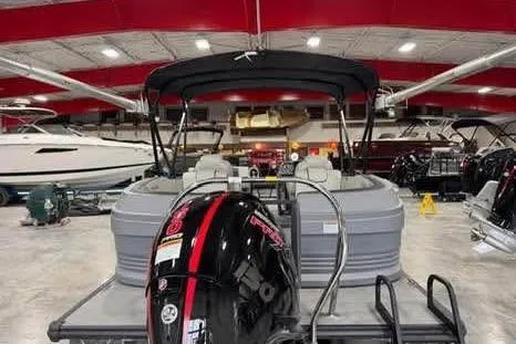 Slide: The Image of 2025 Sylvan A-22 pontoon boat in showroom with outboard motor. - 6