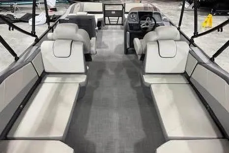 Slide: The Image of 2025 Sylvan A-22 boat interior with spacious seating and modern dashboard design. - 7