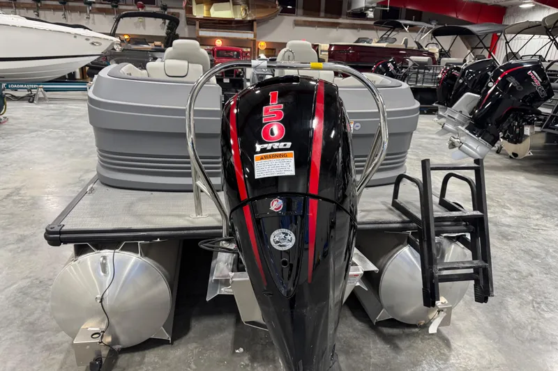 Slide: The Image of 2025 Sylvan A-22 boat with 150 Pro outboard motor in showroom. - 5