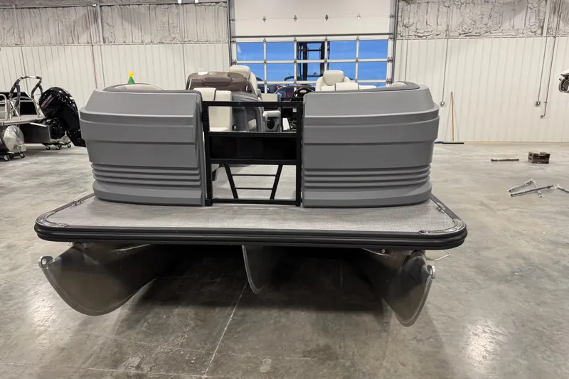 Slide: The Image of 2025 Sylvan A-22 pontoon boat in a spacious indoor showroom. - 6