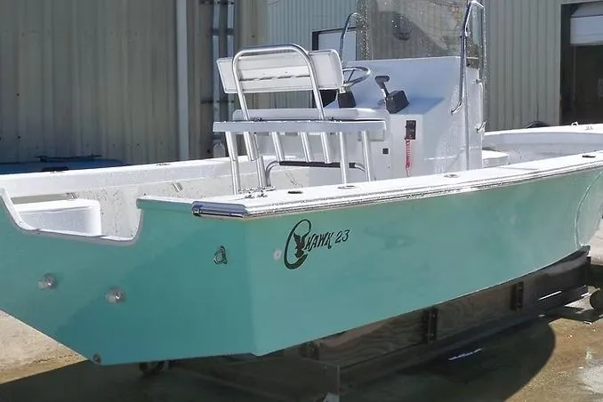Slide: The Image of 2026 C-Hawk 23 Center Console boat with turquoise hull, docked outdoors. - 5