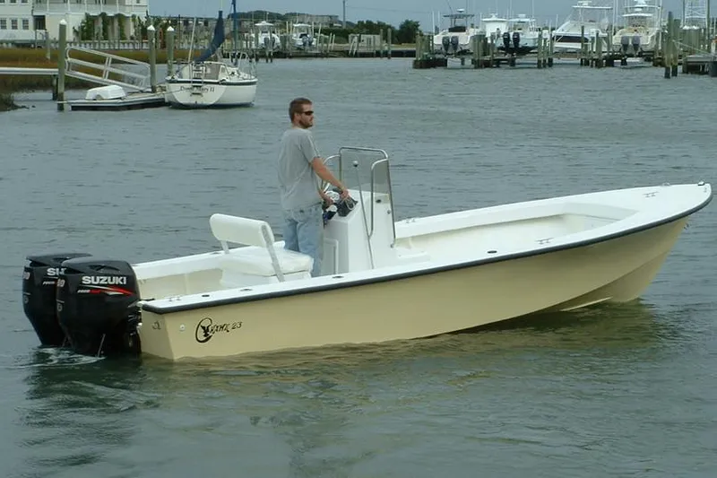 Slide: The Image of Manufacturer Provided Image: 2026 C-Hawk 23 Center Console boat with Suzuki outboard motor on calm water. - 6
