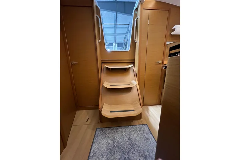 Slide: The Image of Interior of 2023 Jeanneau Sun Odyssey 380 yacht with wooden stairs and modern design. - 25