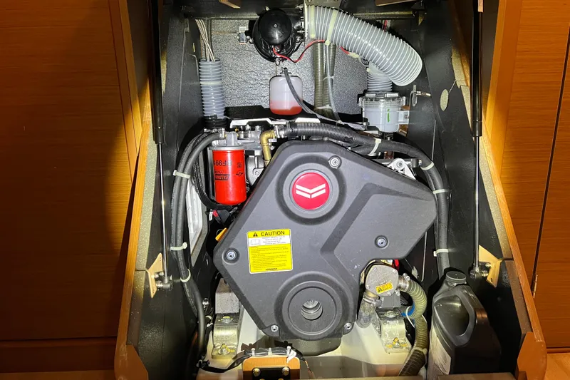 Slide: The Image of Engine compartment of 2023 Jeanneau Sun Odyssey 380 sailboat, showcasing mechanical components. - 26
