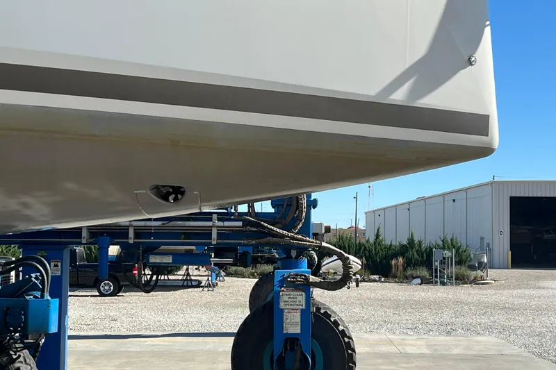 Slide: The Image of 2023 Jeanneau Sun Odyssey 380 yacht on a lift, showcasing hull details. - 8