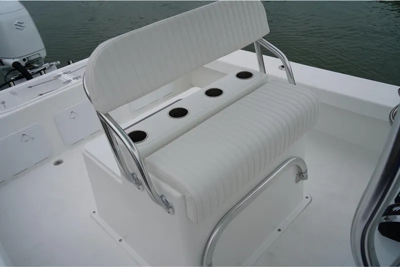 Slide: The Image of 2026 C-Hawk 25 Center Console boat with white seating and cup holders. - 11