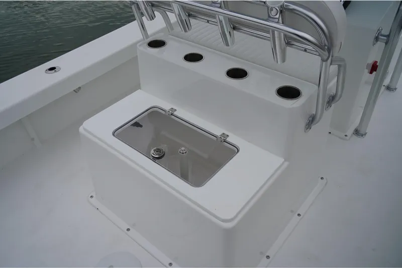 Slide: The Image of 2026 C-Hawk 25 Center Console boat with rod holders and storage compartment. - 12
