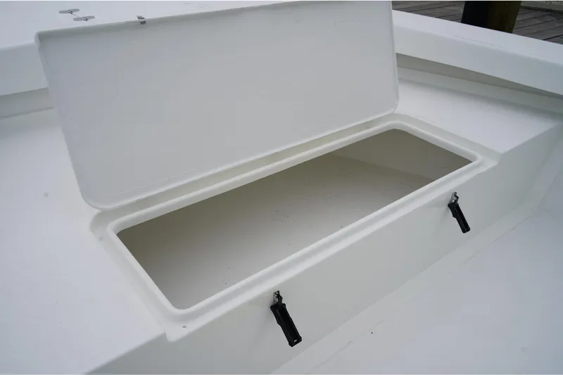 Slide: The Image of Open storage compartment on 2026 C-Hawk 25 Center Console boat. - 13