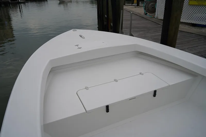 Slide: The Image of 2026 C-Hawk 25 Center Console boat docked at marina, showcasing bow storage area. - 7