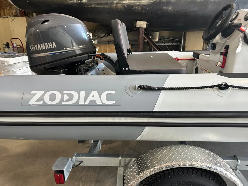 Slide: The Image of 2025 Zodiac Open 4.2 boat with Yamaha engine on trailer in garage. - 10