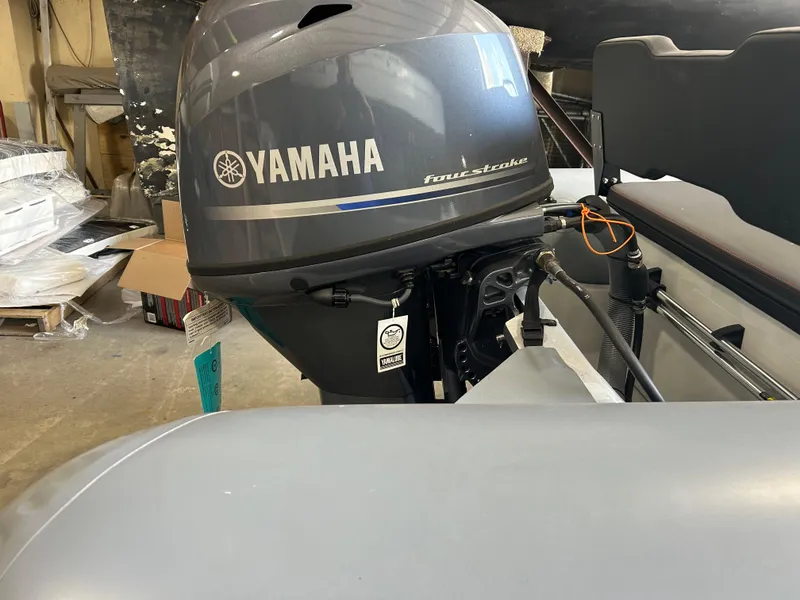 Slide: The Image of 2025 Zodiac Open 4.2 boat with Yamaha four-stroke outboard motor in a workshop. - 11