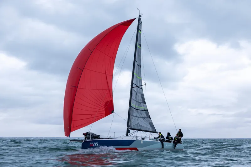 Slide: The Image of 2025 Jeanneau 30 Sun Fast One Design sailing with red spinnaker on open sea. - 6