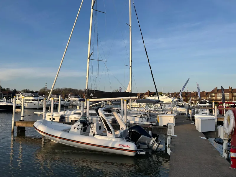 Slide: The Image of 2025 Zodiac Medline 7.5 GT docked at a marina under clear blue skies. - 2