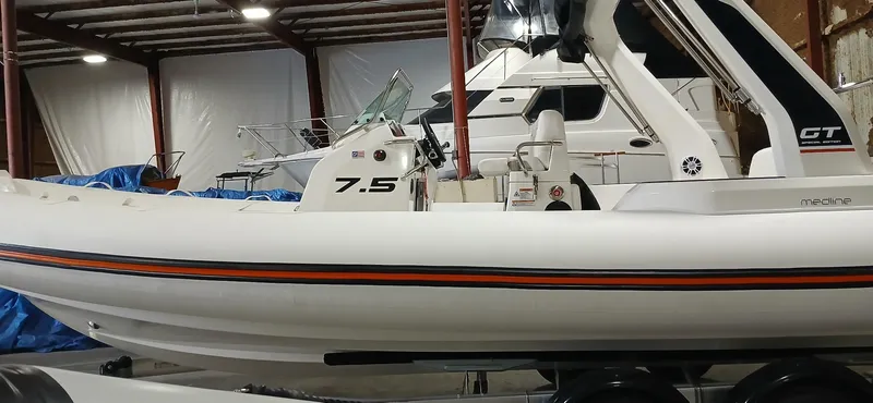 Slide: The Image of 2025 Zodiac Medline 7.5 GT boat in storage, side view, indoors. - 3