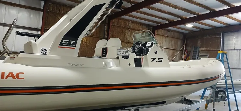 Slide: The Image of 2025 Zodiac Medline 7.5 GT boat in a warehouse, showcasing sleek design and modern features. - 4