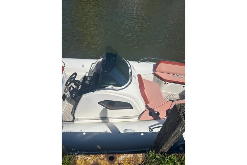 Slide: The Image of 2026 Zodiac Medline 9 boat with sleek design and comfortable seating on calm water. - 12