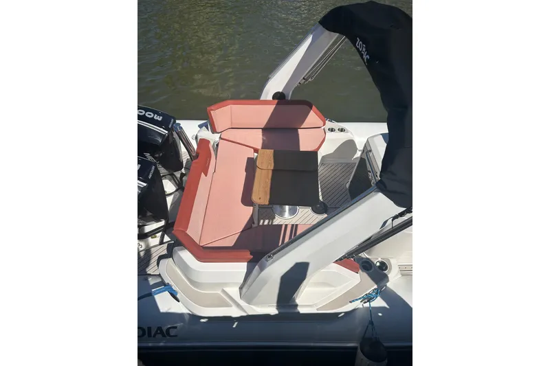 Slide: The Image of 2026 Zodiac Medline 9 boat interior with red seating and wooden accents on water. - 14