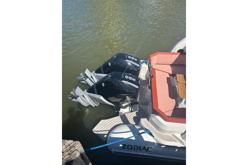 Slide: The Image of 2026 Zodiac Medline 9 boat with dual outboard motors, docked on calm water. - 15