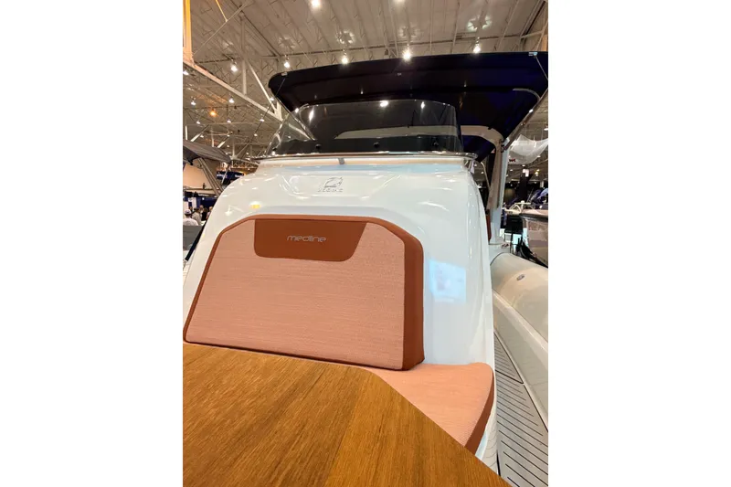 Slide: The Image of 2025 Zodiac Medline 9 boat interior with cushioned seating and wooden table. - 17