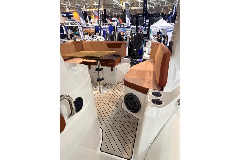 Slide: The Image of 2025 Zodiac Medline 9 boat interior with seating and table at a boat show. - 8
