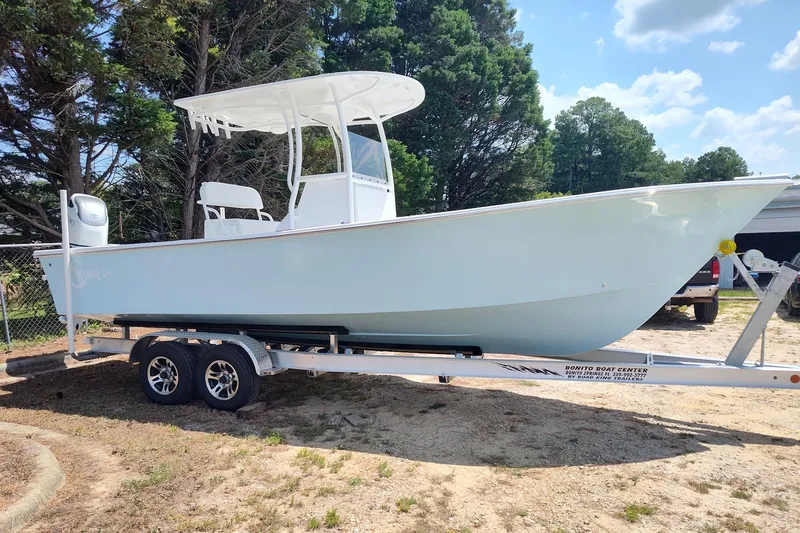 The Image of 2026 C-Hawk 26 Center Console boat on trailer, parked outdoors. - 0