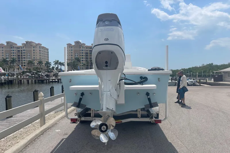 Slide: The Image of 2026 C-Hawk 26 Center Console boat with outboard motor at marina dock. - 2