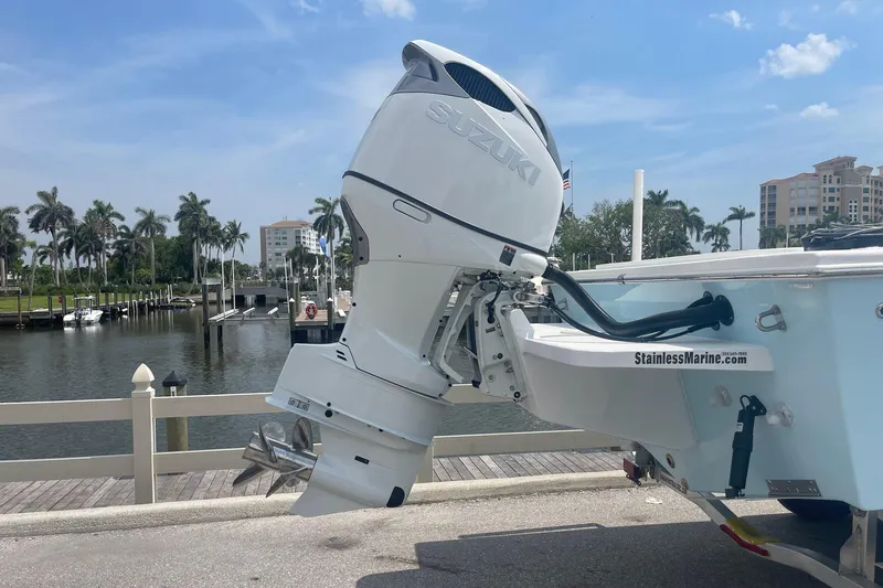 Slide: The Image of 2026 C-Hawk 26 Center Console with Suzuki outboard motor at marina dock. - 3