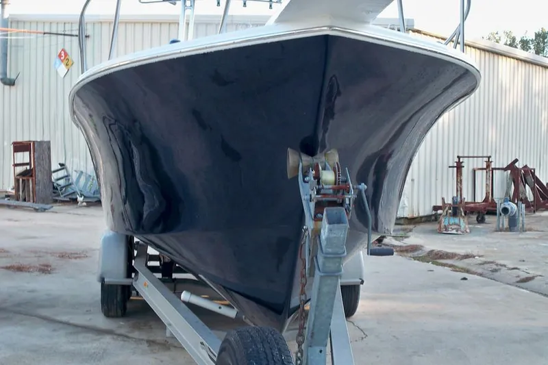 Slide: The Image of Manufacturer Provided Image: 2026 C-Hawk 26 Center Console boat on trailer, parked in industrial area. - 9