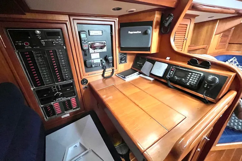 Slide: The Image of Navigation station of 2004 Hylas 49 yacht with control panels and communication equipment. - 11