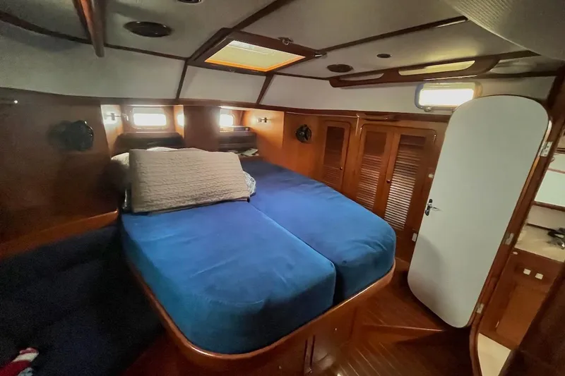 Slide: The Image of Luxurious cabin interior of a 2004 Hylas 49 yacht with blue bedding. - 14