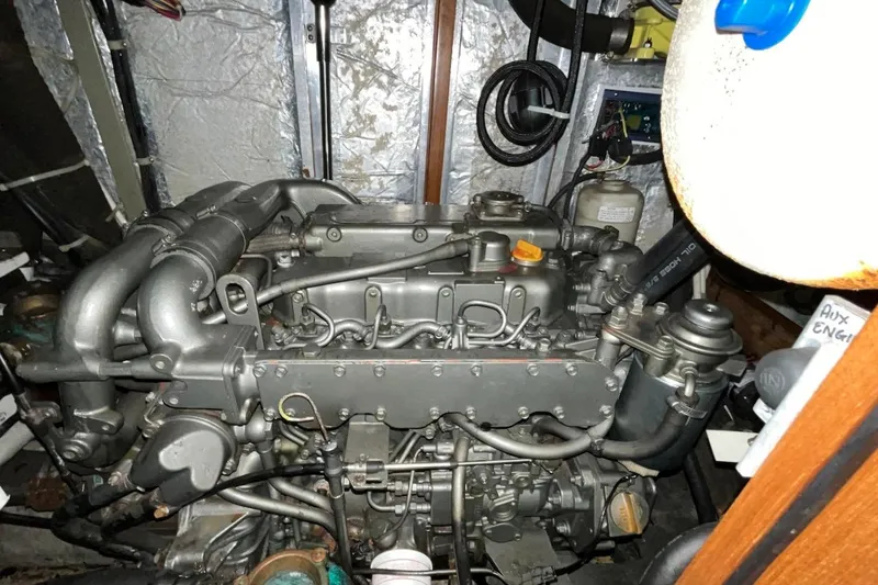 Slide: The Image of Engine compartment of a 2004 Hylas 49 sailboat, showcasing detailed mechanical components. - 18
