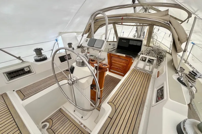 Slide: The Image of 2004 Hylas 49 yacht cockpit with steering wheel, navigation equipment, and teak flooring. - 6