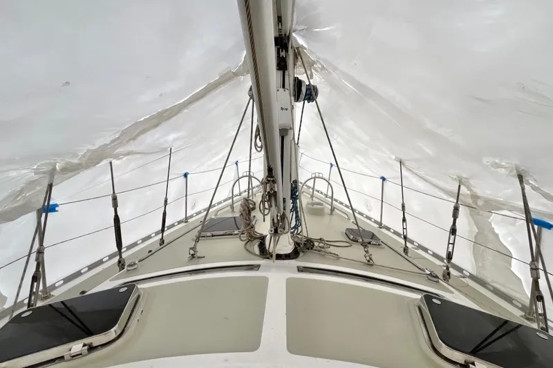 Slide: The Image of 2004 Hylas 49 sailboat deck under protective cover, showcasing rigging and structure. - 7