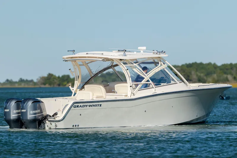 The Image of 2020 Grady-White Freedom 307 boat cruising on a calm lake with twin Yamaha engines. - 0