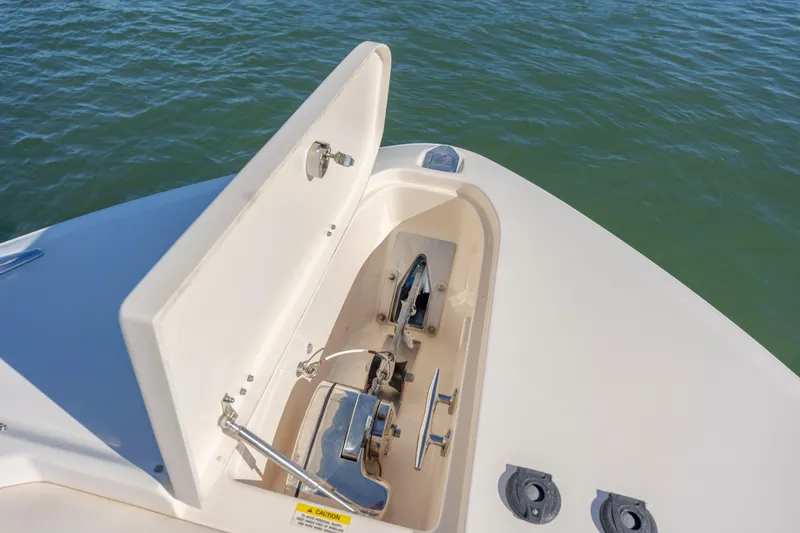 Slide: The Image of 2020 Grady-White Freedom 307 boat anchor compartment open on calm water. - 10