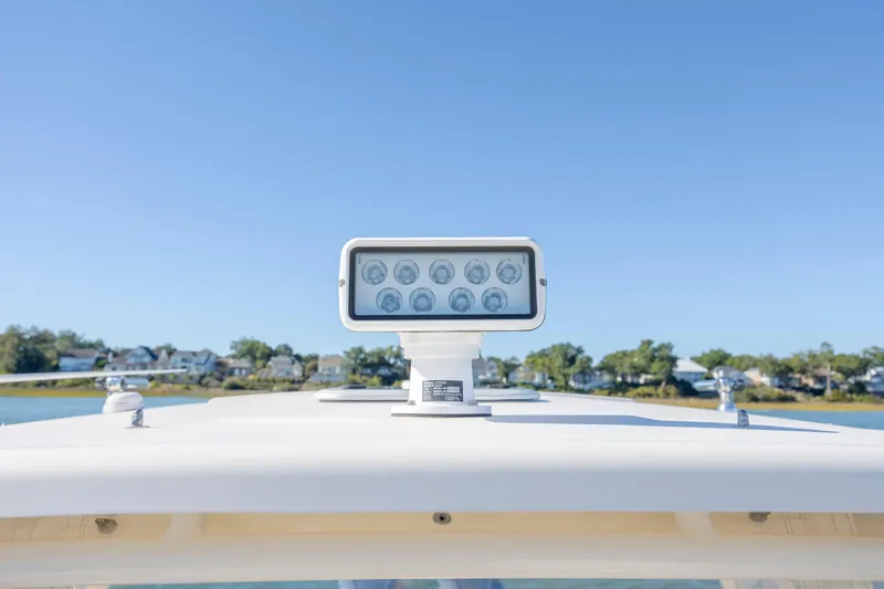 Slide: The Image of 2020 Grady-White Freedom 307 boat spotlight against clear blue sky. - 12