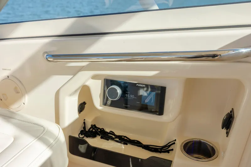 Slide: The Image of 2020 Grady-White Freedom 307 boat interior with Fusion stereo system and cup holder. - 14