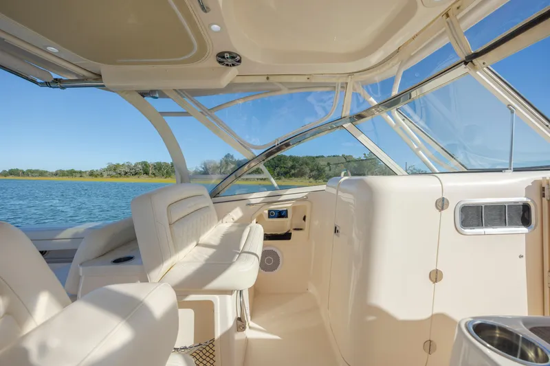 Slide: The Image of 2020 Grady-White Freedom 307 boat interior with seating and water view. - 15