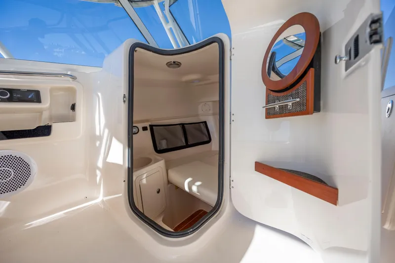 Slide: The Image of 2020 Grady-White Freedom 307 cabin interior with seating and storage. - 16