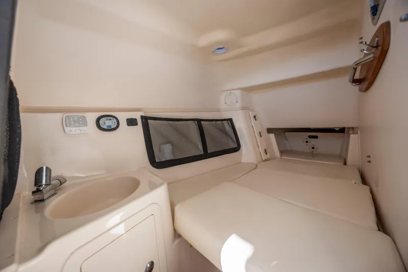 Slide: The Image of 2020 Grady-White Freedom 307 cabin interior with sink and seating area. - 17