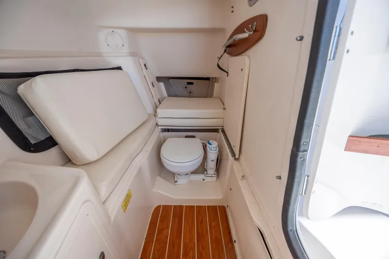 Slide: The Image of 2020 Grady-White Freedom 307 boat interior with toilet and seating area. - 18