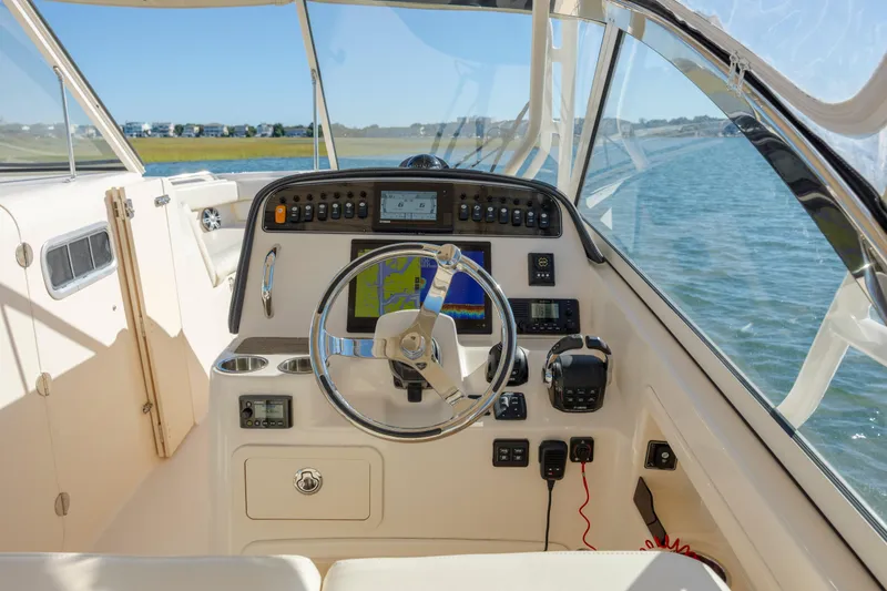 Slide: The Image of 2020 Grady-White Freedom 307 boat cockpit with steering wheel and navigation system. - 22