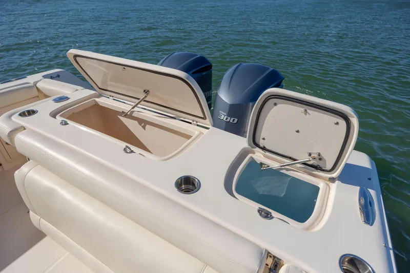 Slide: The Image of 2020 Grady-White Freedom 307 boat with open storage compartments and twin Yamaha engines. - 29