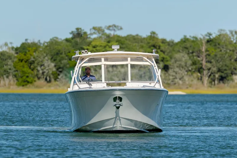 Slide: The Image of 2020 Grady-White Freedom 307 boat cruising on a serene lake. - 3