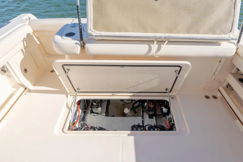 Slide: The Image of 2020 Grady-White Freedom 307 boat interior with open hatch revealing wiring and components. - 30