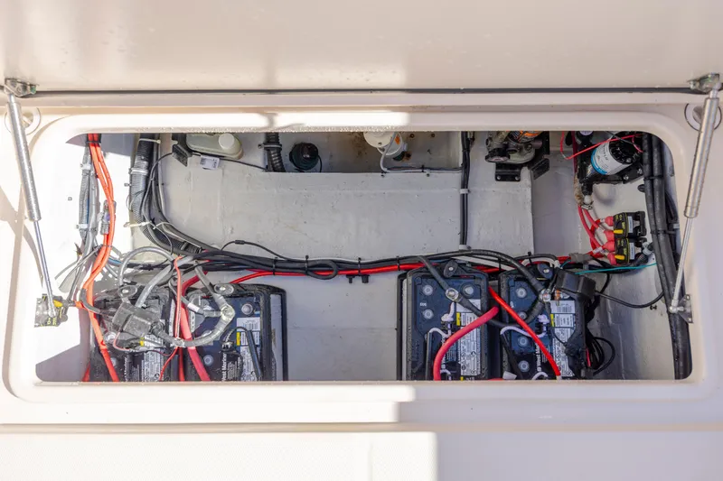 Slide: The Image of 2020 Grady-White Freedom 307 boat battery compartment with wiring and components. - 31