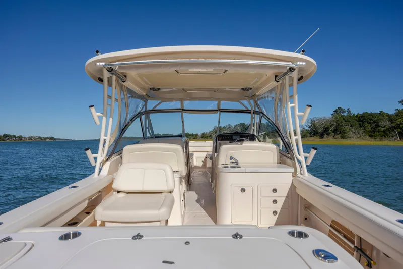 Slide: The Image of 2020 Grady-White Freedom 307 boat interior on calm water, clear blue sky. - 35