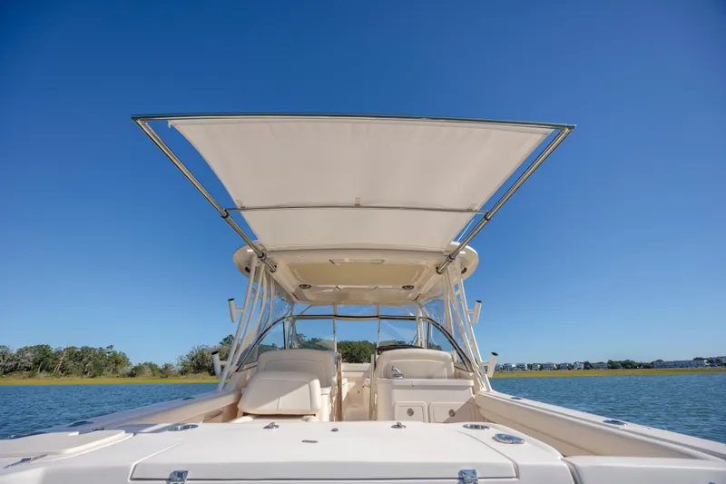 Slide: The Image of 2020 Grady-White Freedom 307 boat on water under clear blue sky. - 37